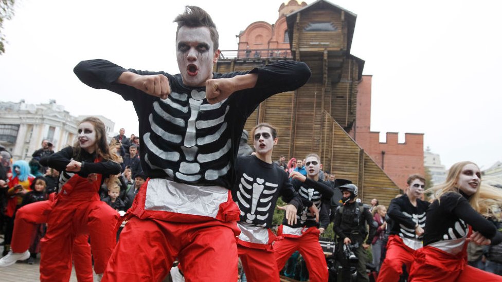 Dancers wearing make-up and zombie costumes attend the Halloween parade in Kiev in 2019