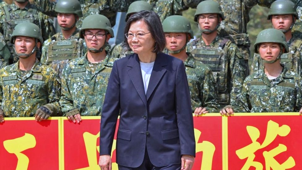 Taiwan's President Tsai Ing-wen (C) poses for photographs with combat engineer troops during a visit in Chiayi county on March 25, 2023.