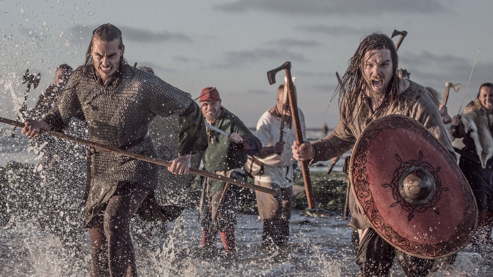 A group of actors recreate a Viking battle.