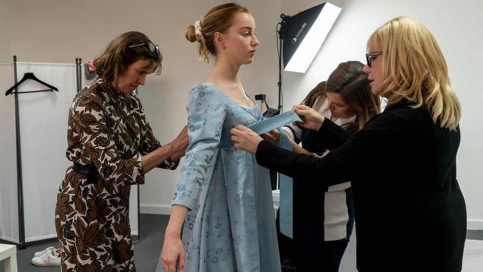Phoebe Dynevor having her costume fitted