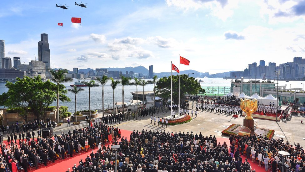 Флаги Китая и Гонконга несут вертолеты во время церемонии на площади Золотой Баухинии в Гонконге, 1 июля 2017 г.