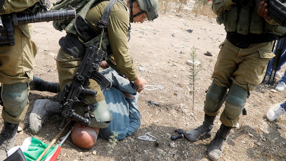 Israeli Soldier Condemned For Putting Knee On Palestinian Protesters Neck Bbc News 3413