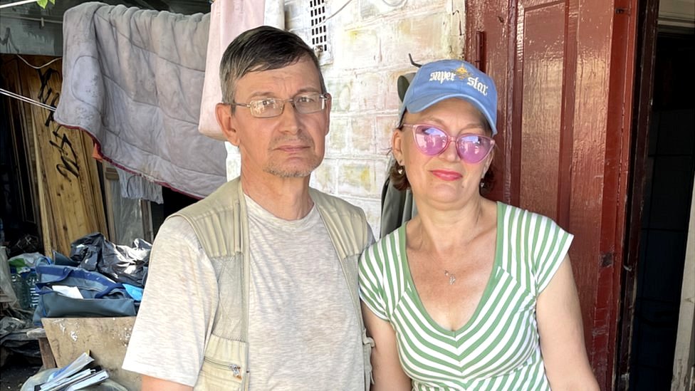 Irina (R) a 73-year-old retired teacher, with her husband, Evhenii