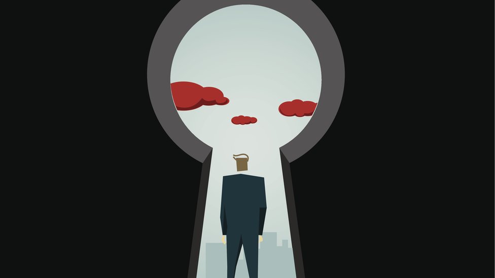 Hombre mirando a través de un agujero gigante para la llave de una puerta