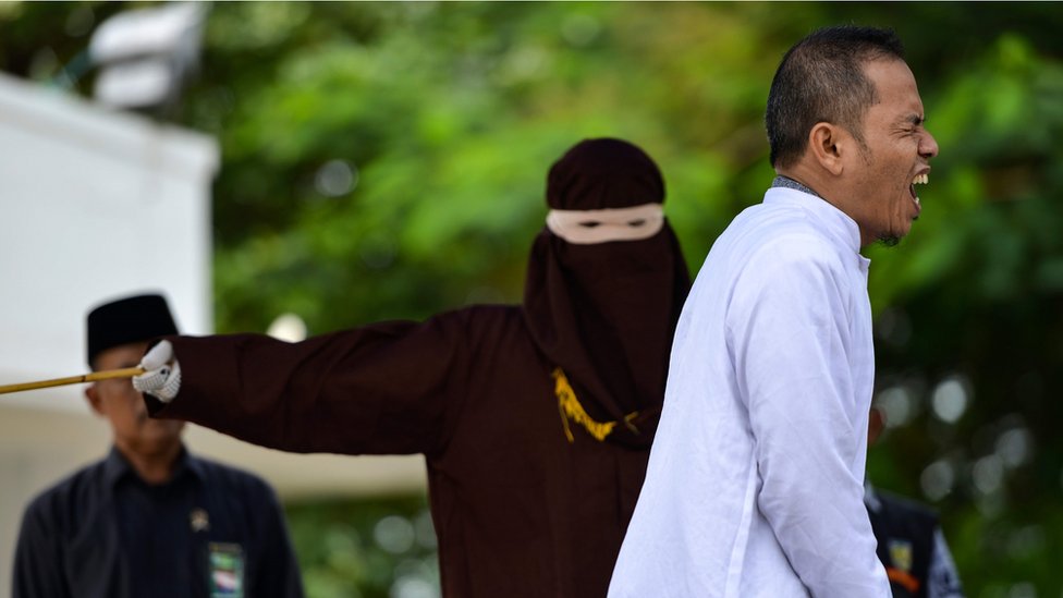 Indonesian man who helped set strict adultery laws flogged for