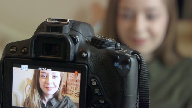 Vlogger Anastasia looking into a camera