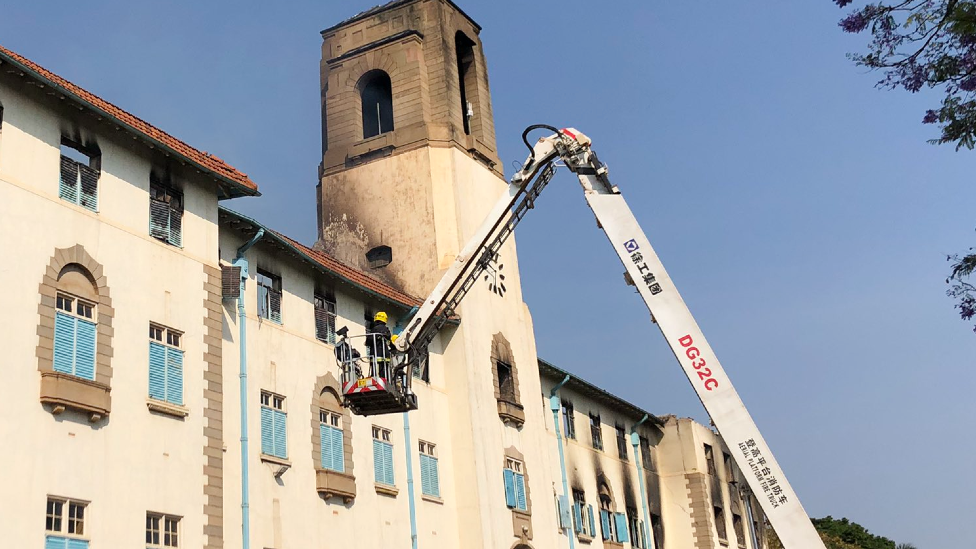 A photo tweeted by Makerere University showing firemen investigating the "Ivory Tower" the morning after the blaze, Kampala, Uganda - 20 September 2020