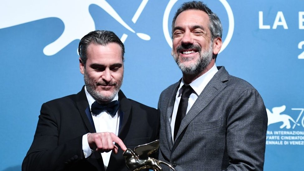 Joaquin Phoenix (left) and Todd Phillips with the best film statuette in Venice