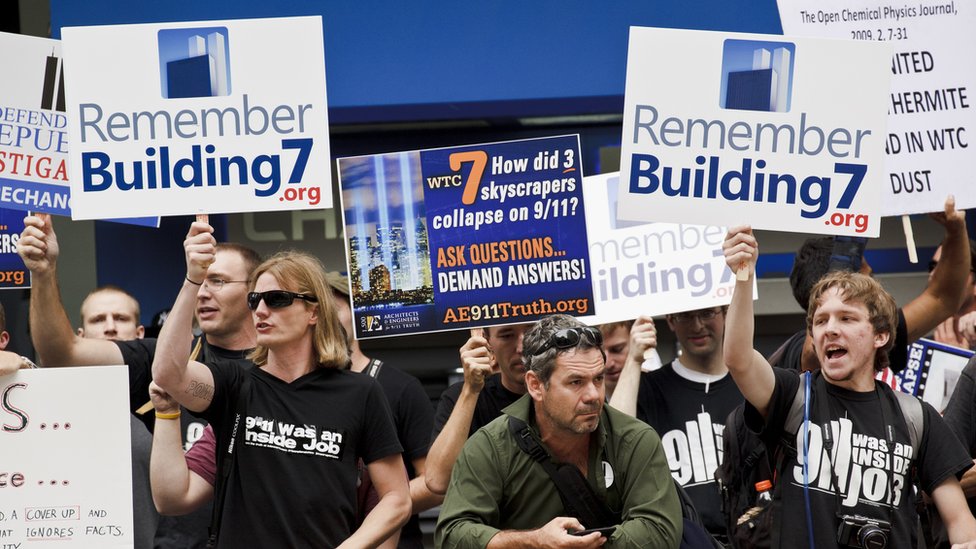 9/11 conspiracy theorists protest outside the memorial service at the World Trade Center construction site marking the 10th anniversary of the attacks on September 11, 2001.