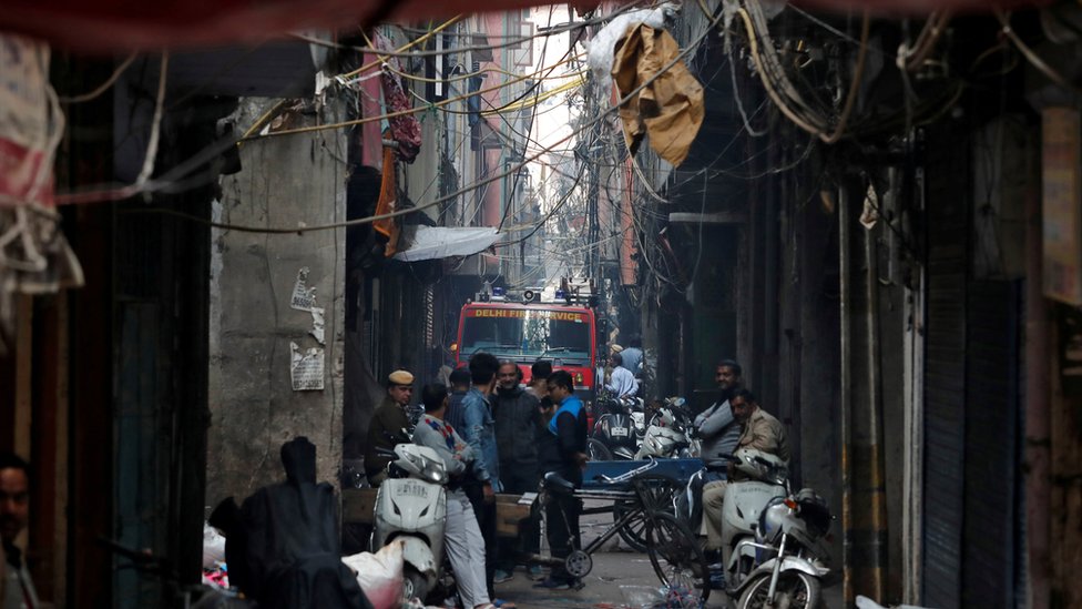 A fire engine is seen down an alleyway