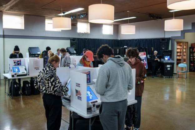 Voters cast ballots at a polling location inside a church in Columbus
