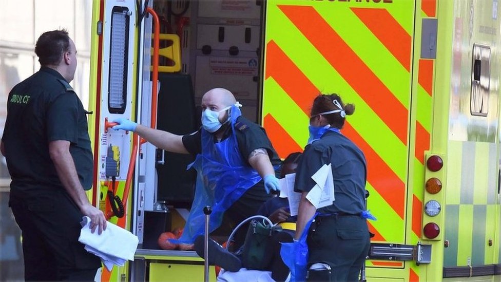 Coronavirus patient being helped into ambulance