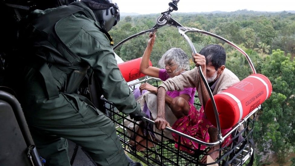 People are airlifted by the Indian Navy soldiers during a rescue operation at a flooded area in the southern state of Kerala, India, 17 August 2018
