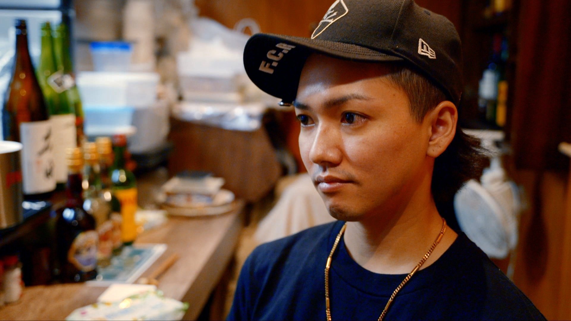 Ryu - young man in bar wearing baseball cap
