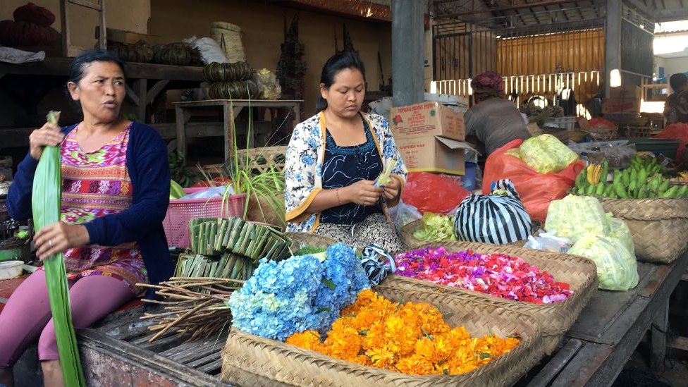 Торговцы сортируют еду в тихой рыночной зоне