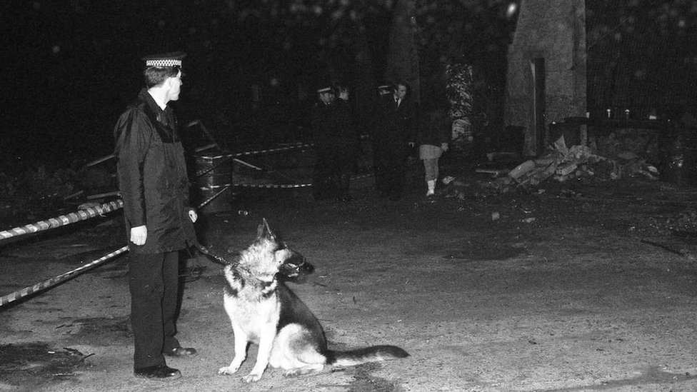 Police officer and dog at rave in Colnbrook
