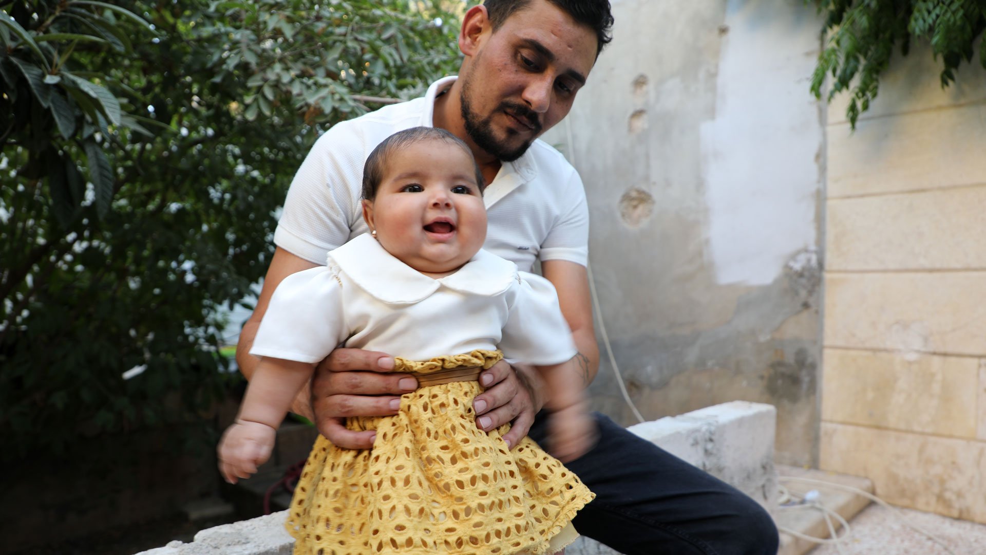 Baby Afraa smiling with her uncle