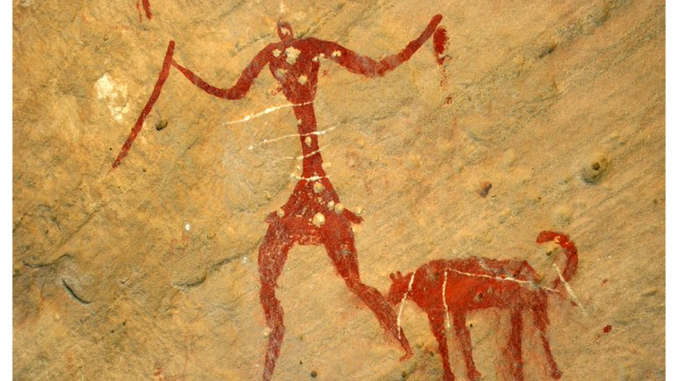 Cave painting of a hunter and what is believed to be his dog