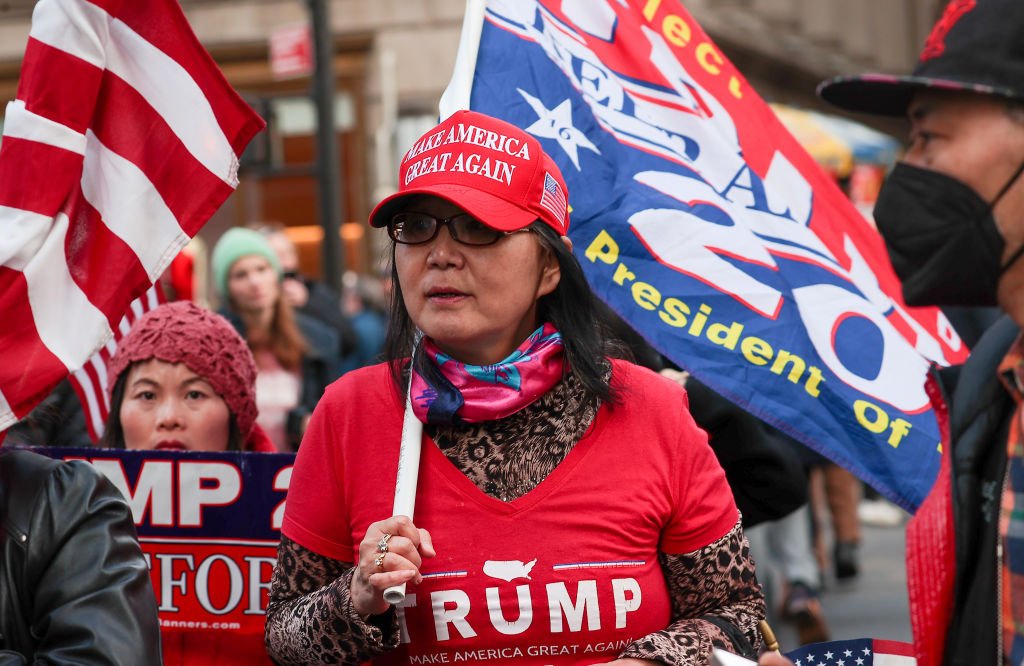 Militante de Donald Trump con camiseta, gorro y bandera alusivos al expresidente afuera de la oficina del fiscal de distrito de Manhattan en la ciudad de Nueva York el 3 de abril de 2023.