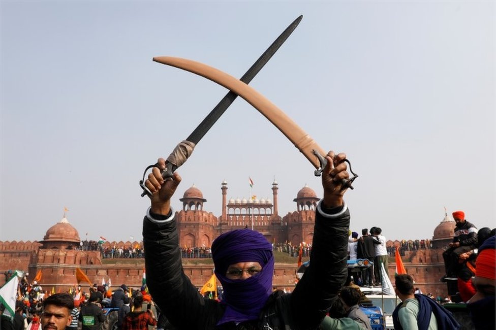 A farmer holds a sword during a protest against farm laws introduced by the government, at the historic Red Fort in Delhi, India, January 26, 2021