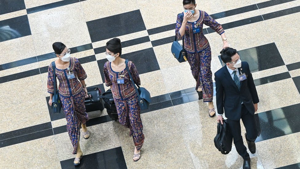 新加坡樟宜機場內一群新加坡航空機組人員走過轉機大廳（12/1/2022）