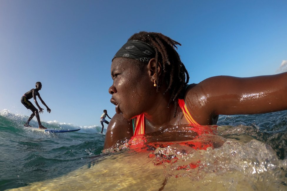 Khadjou Sambe surfs in the ocean