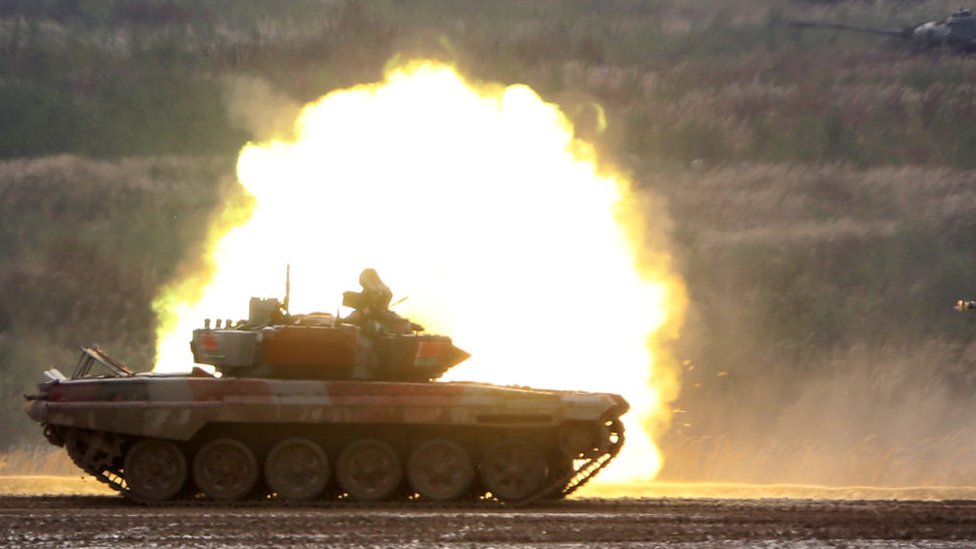 Tank on a military range against the background of an explosion