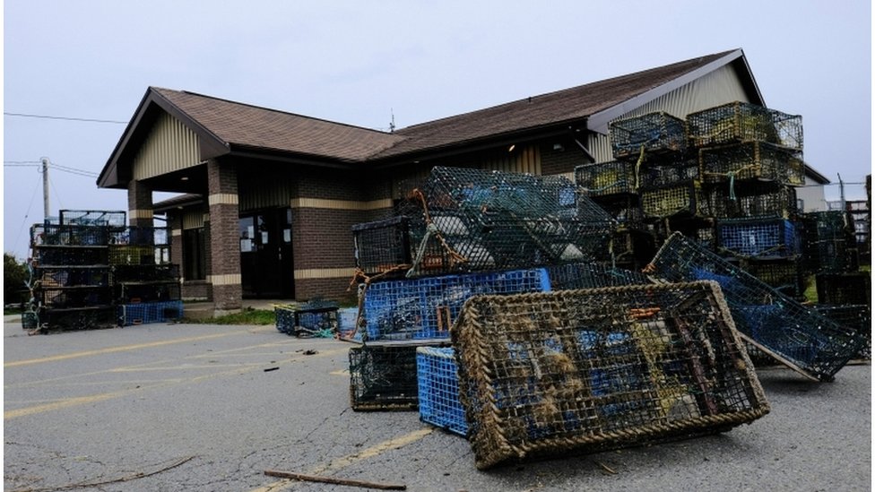 Lobster traps that were seized by non-native fishers lie dumped outside the DFO office