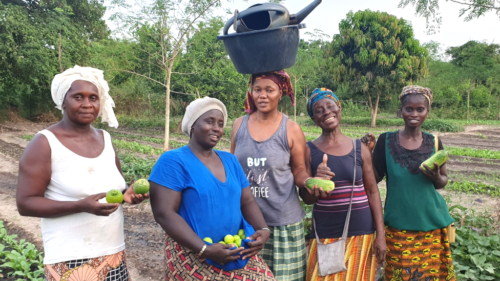Female farmers in Casamance, Senegal, holding fruit