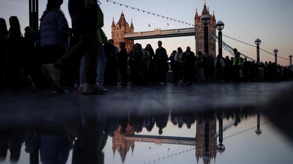 People queue by the Tower Bridge to pay their respects to Britain's Queen Elizabeth following her death, in London, Britain, September 17, 2022