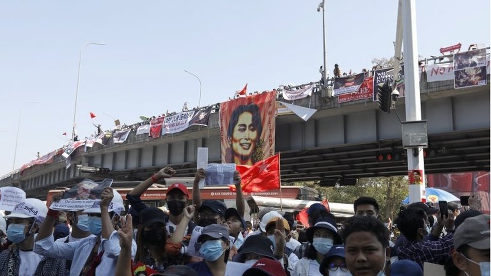 Demonstrators hold placards and shout slogans during a protest against the military coup at the Hledan junction in Yangon, Myanmar, 10 February 2021.