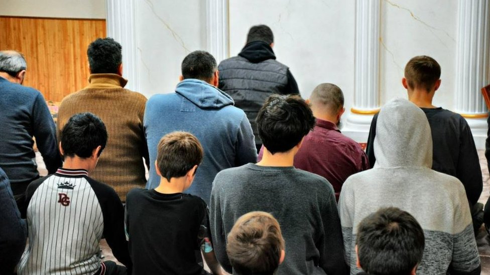 Muslim men praying in a mosque
