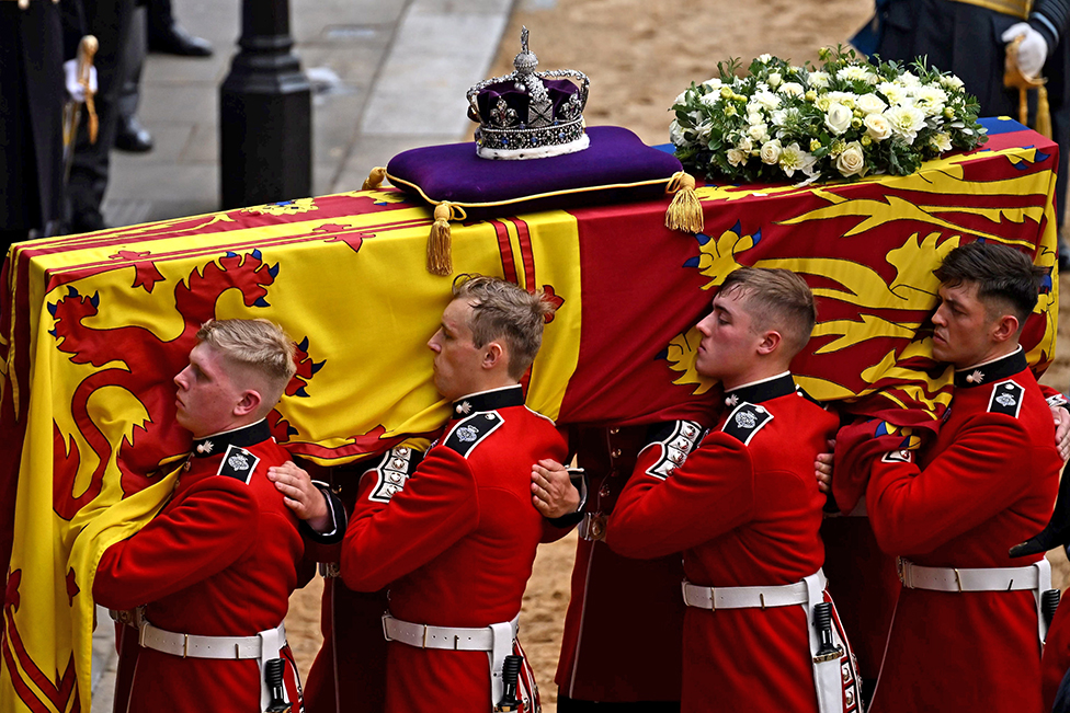 The Bearer Party from Queen's Company, 1st Battalion Grenadier Guards, carries the coffin of Queen Elizabeth II, draped in the Royal Standard with the Imperial State Crown placed on top, into Westminster Hall, London on 14 September 2022
