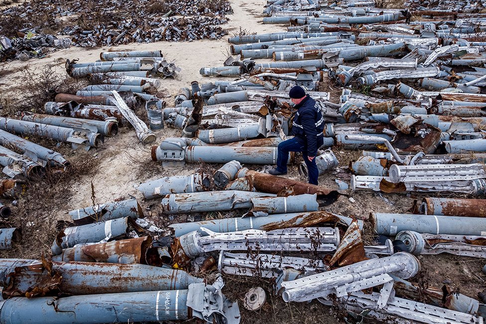 An aerial view of an expert of the Ukrainian prosecutor's office examining collected remnants of shells and missiles used by the Russian army, 7 December 2022.