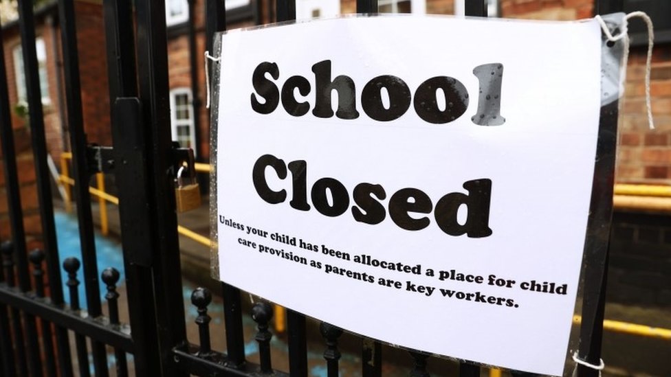 Sign on school gate saying 'School Closed'