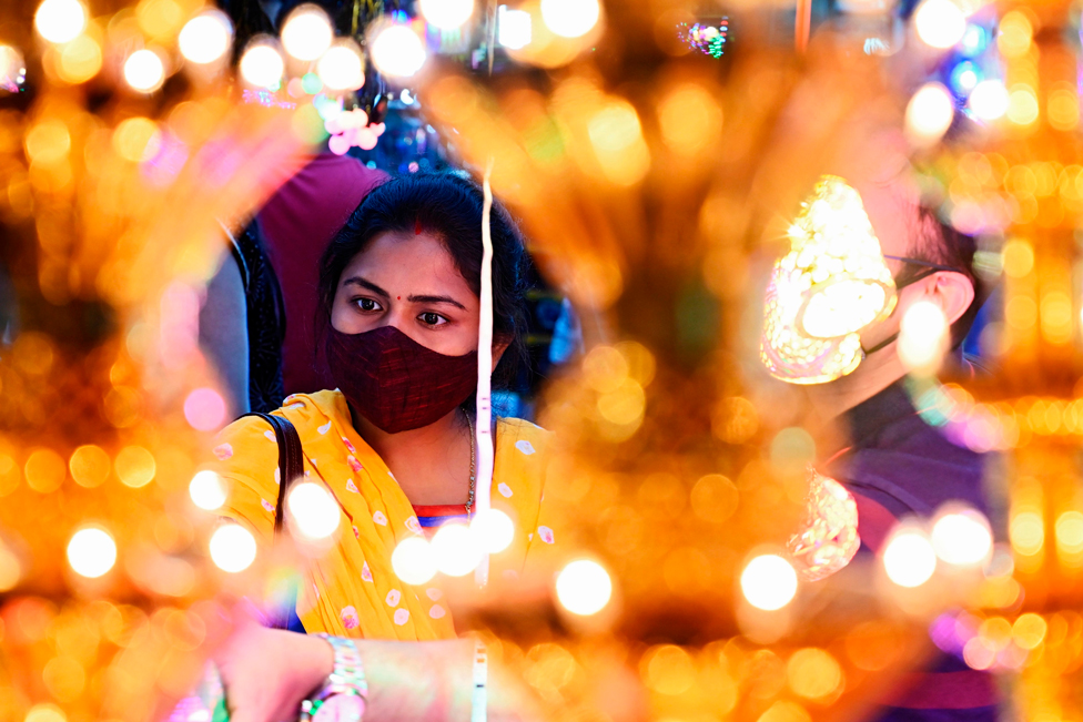 A woman shops for decorative items at a roadside market