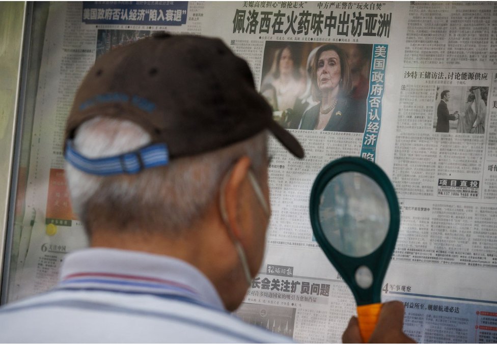一名男子正在閲讀中國官媒《環球時報》，該報紙刊登了一篇關於美國的頭版文章。 標題為：「佩洛西在火藥味中出訪亞洲」。