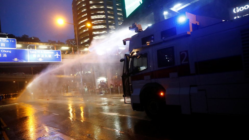 A water cannon is fired at protesters