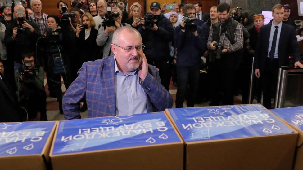 Boris Nadezhdin stands in front of boxes with journalists and camera people behind him at Central Election Commission, Moscow, Russian Federation on 31 Jan 2024