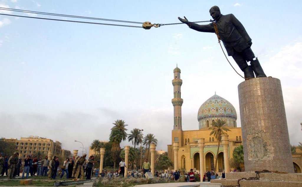 US troops topple a statue of Saddam Hussein in Baghdad, 9 April 2003