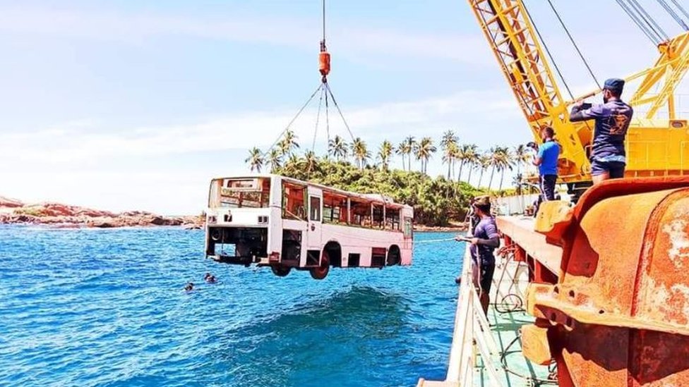 A bus is being lowered into sea