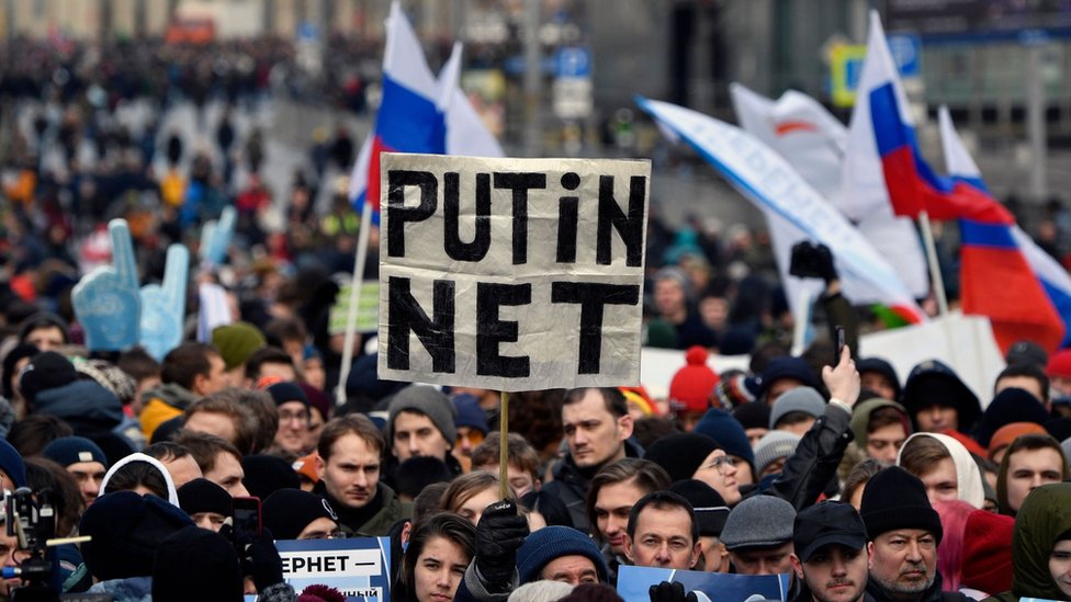 A protester holds a placard reading "Putin - No!" during an opposition rally in central Moscow, on 10 March