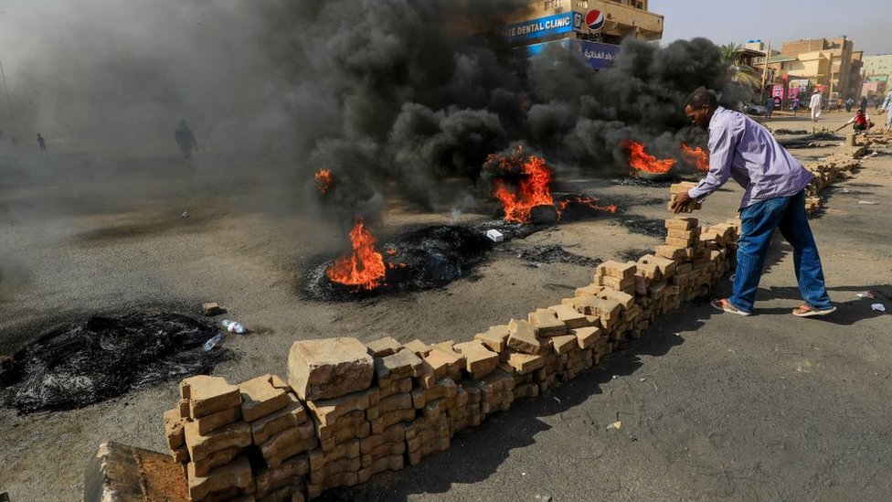 Demonstrators block roads in Khartoum in protest at the arrests