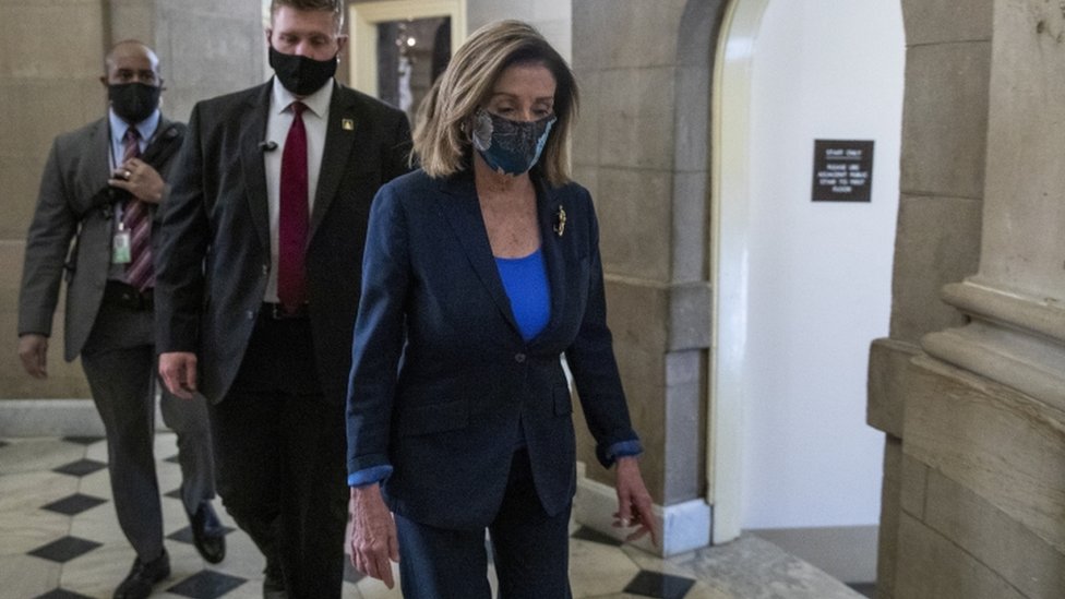 Speaker of the House Nancy Pelosi walks to her office from the House floor