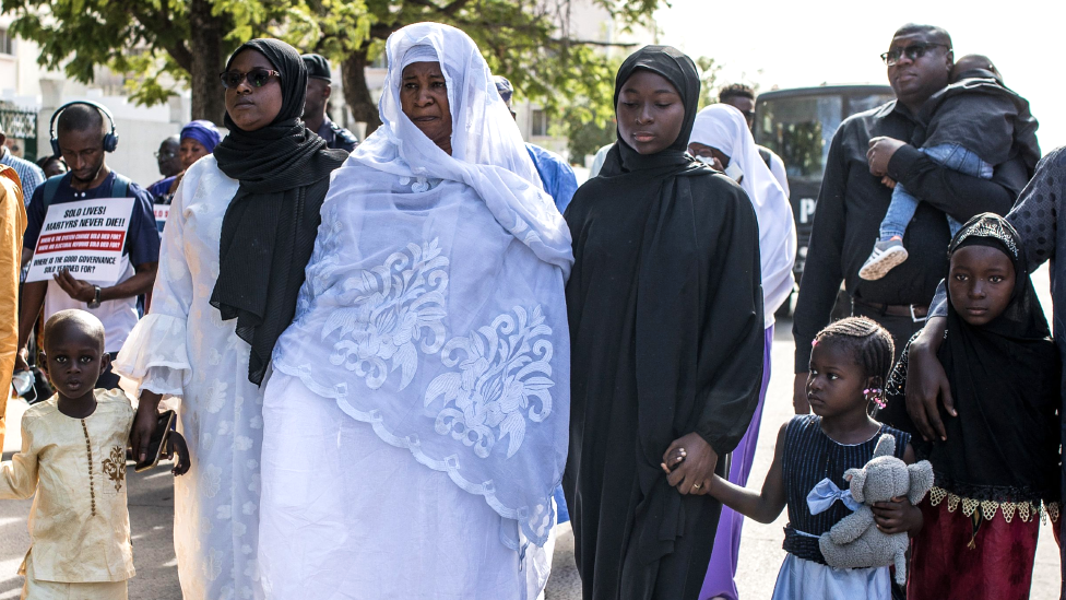 Family members of Ebrima Solo Sandeng walk behind the hearse carrying his coffin at a funeral in Banjul, The Gambia - 10 January 2023
