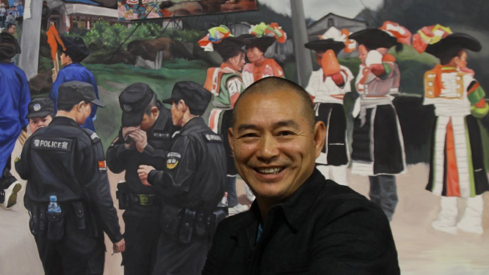 Guo Jian in front of one of his paintings