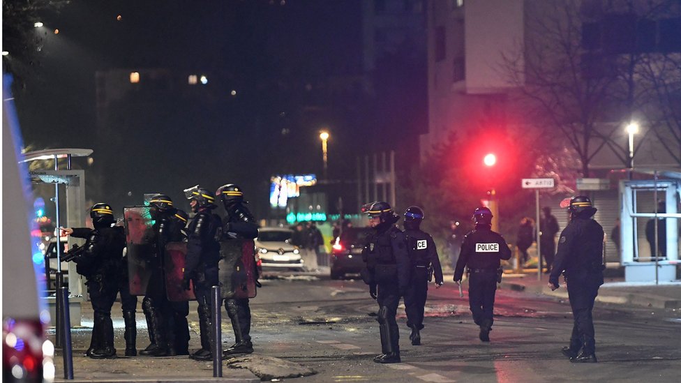 Police stand in the street in Grenoble