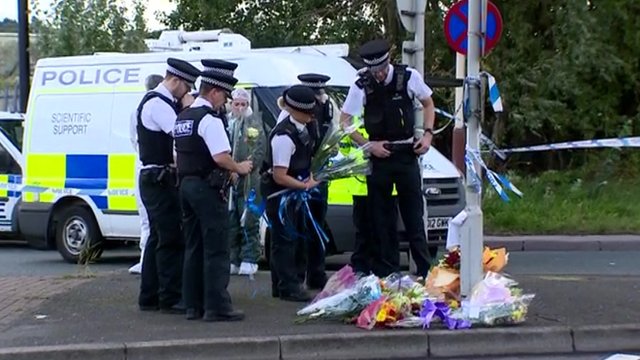 Police lay flowers at scene