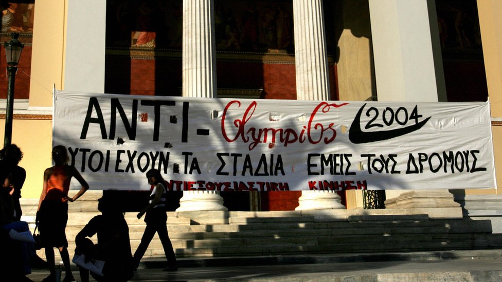 Баннер с надписью «У них есть стадионы - у нас есть улицы» размещен перед входом в Афинский университет во время демонстрации против олимпиады.