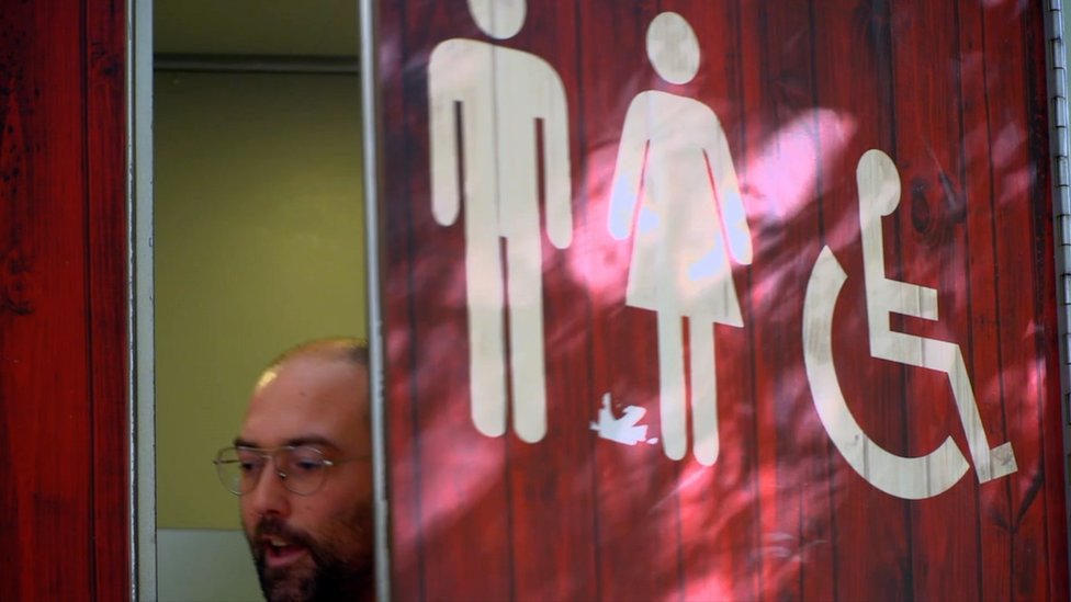 A man coming out of a toilet in Barcelona